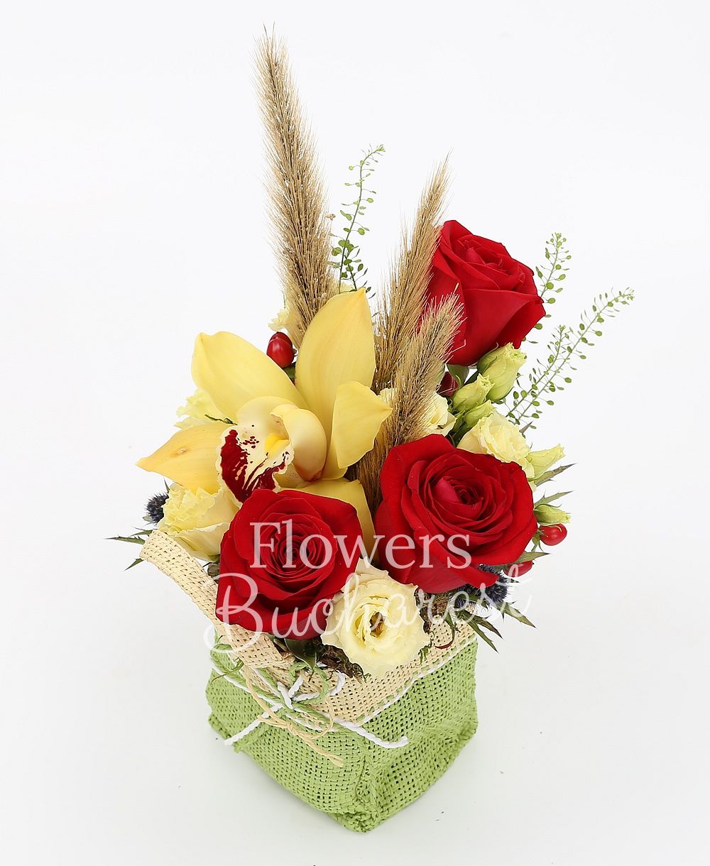 3 red roses, 2 cream lisianthus, yellow cymbidium, 2 eryngium, 3 red hypericum, greenery