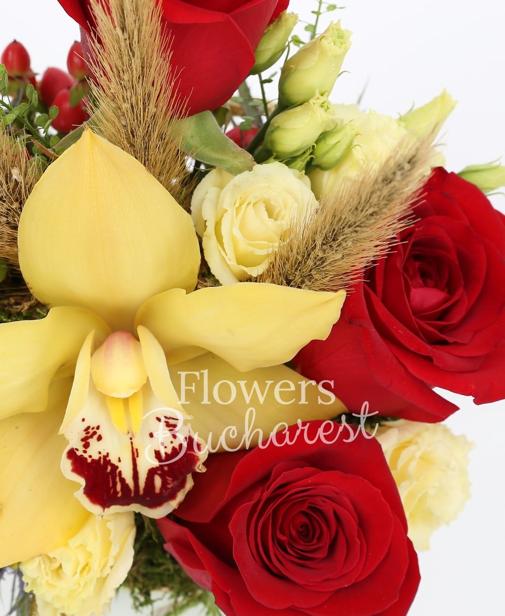 3 red roses, 2 cream lisianthus, yellow cymbidium, 2 eryngium, 3 red hypericum, greenery