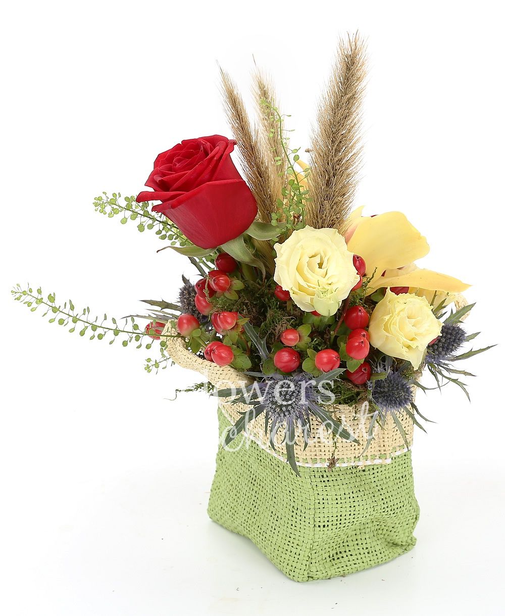 3 red roses, 2 cream lisianthus, yellow cymbidium, 2 eryngium, 3 red hypericum, greenery