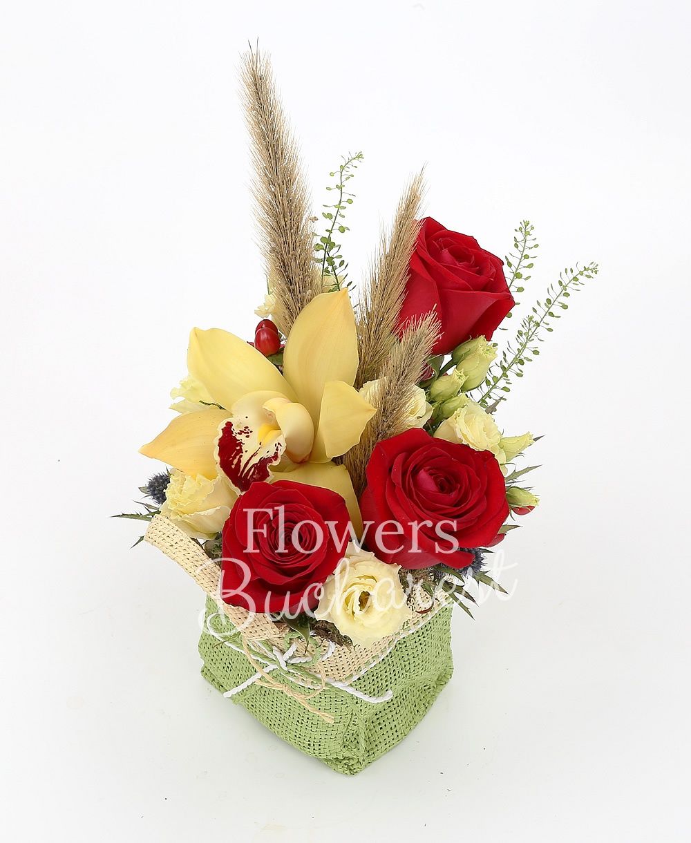 3 red roses, 2 cream lisianthus, yellow cymbidium, 2 eryngium, 3 red hypericum, greenery