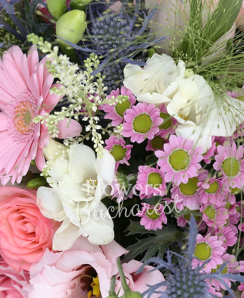 7 pink roses, 5 pink gerberas, 3 purple cala, 3 pink santini, 3 pink lisianthus, 10 white freesias, 3 eryngium, 5 purple veronica, 3 white trachelium, greenery