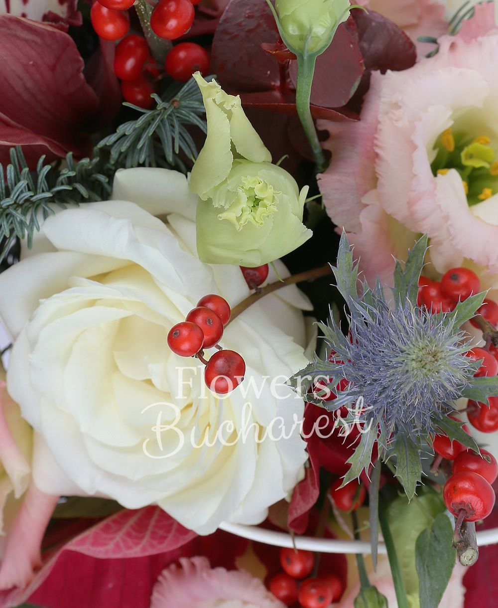 3 white roses, 1 garnet cymbidium, 3 pink lisianthus, ilex, eryngium, poinsettia, greenery