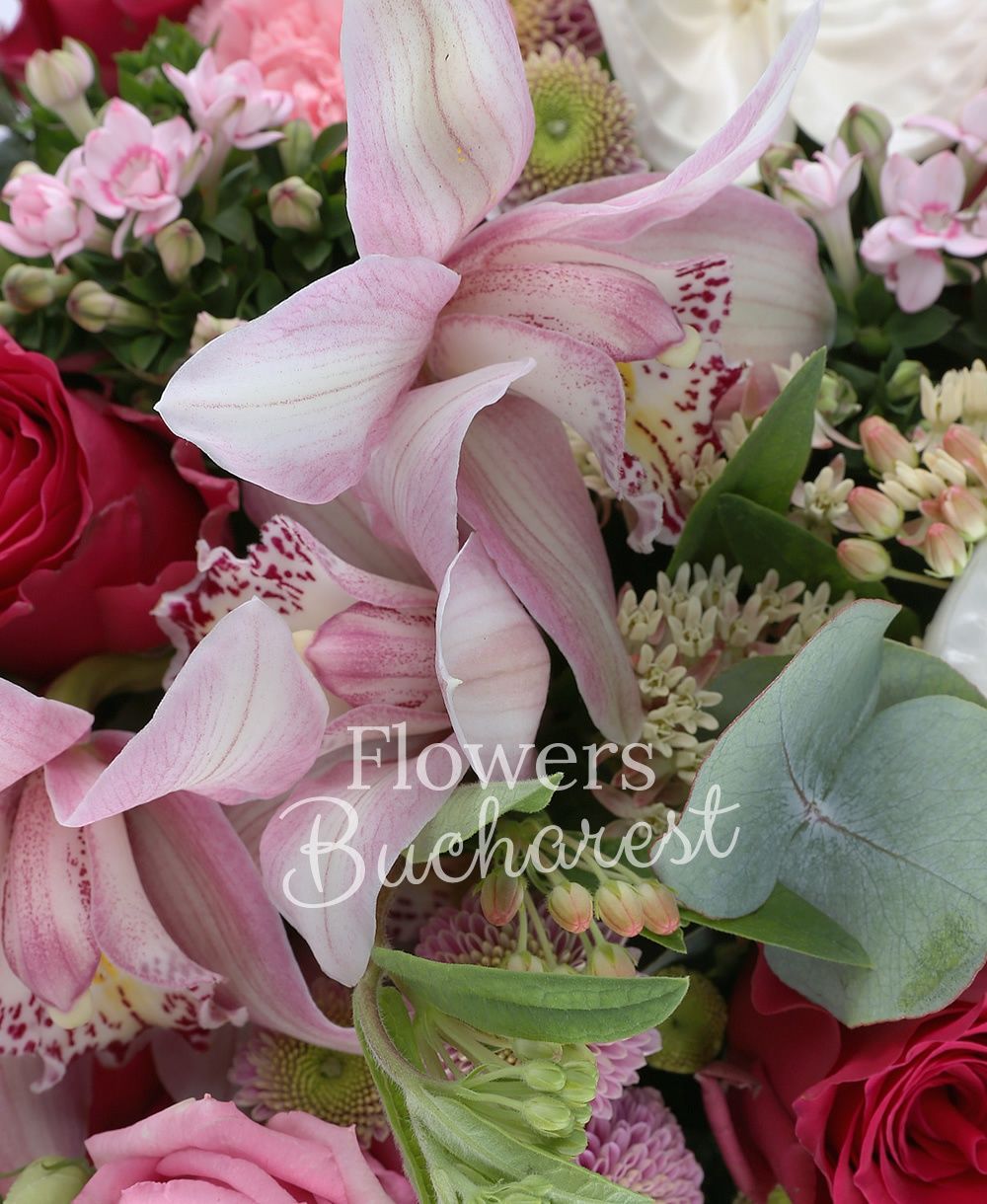 7 red roses, 5 pink bouvardia, 5 pink carnations, 5 pink santini, 2 white anthurium, pink cymbidium, greenery