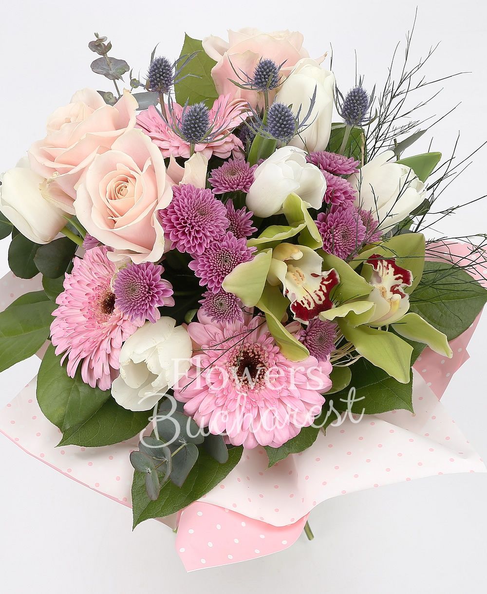 3 pink roses, 2 pink gerbera, 5 white tulips, 2 pink santini, 2 eryngium, green cymbidium, greenery