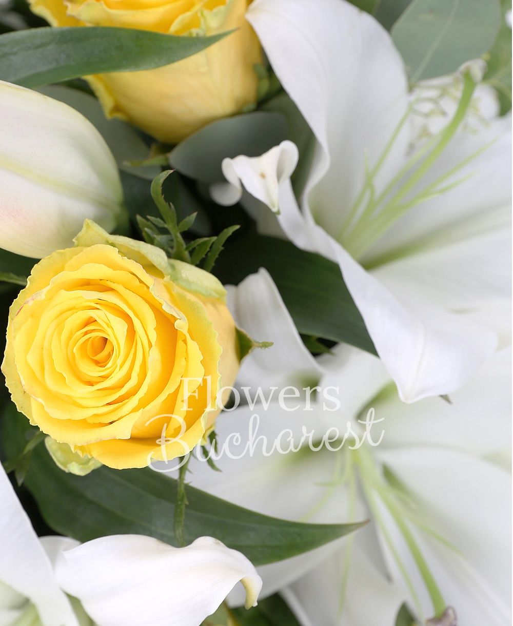 9 yellow roses, 4 white lilies, greenery