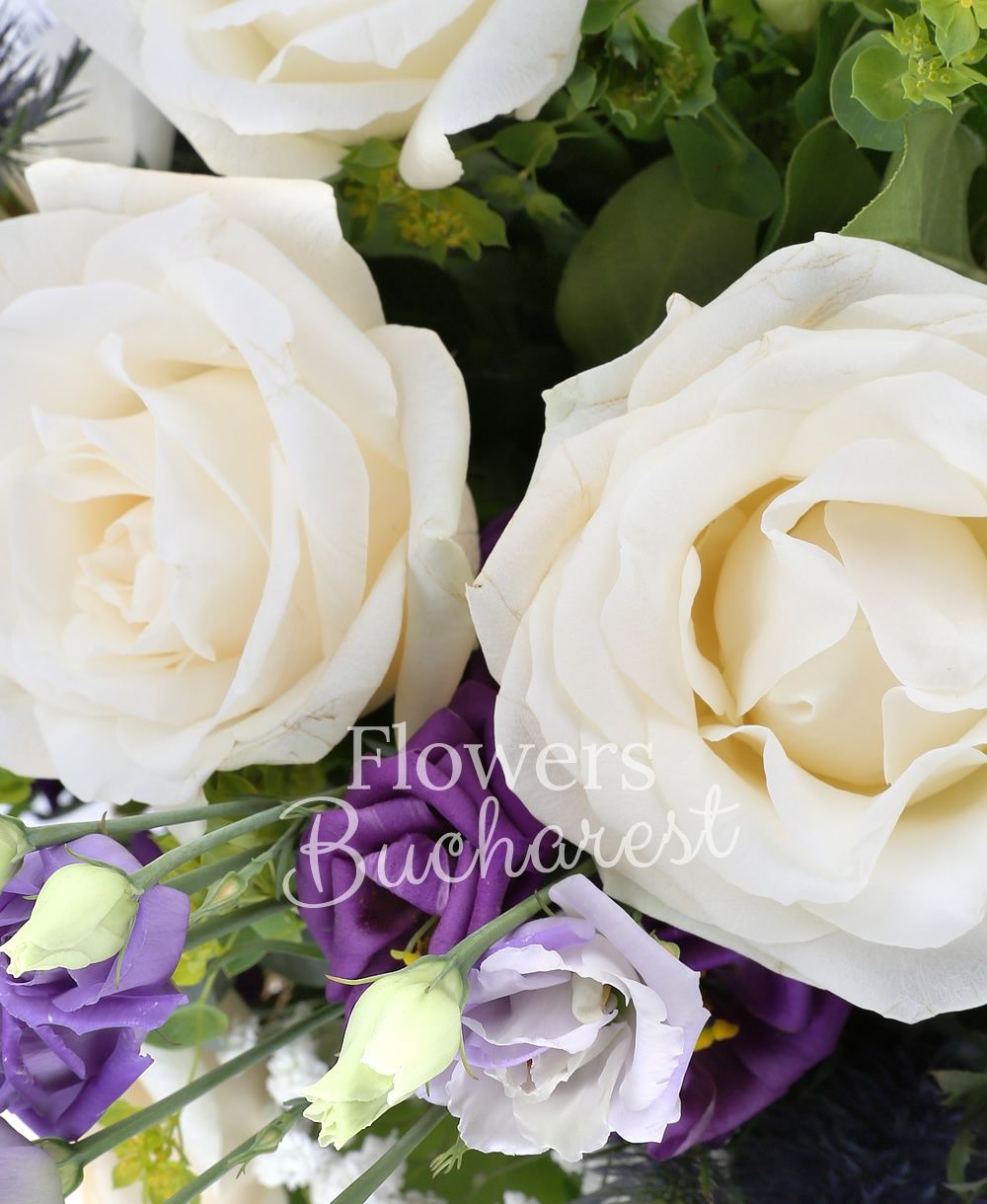 5 white roses, 3 purple lisianthus, 3 eryngium, 7 white freesias, greenery