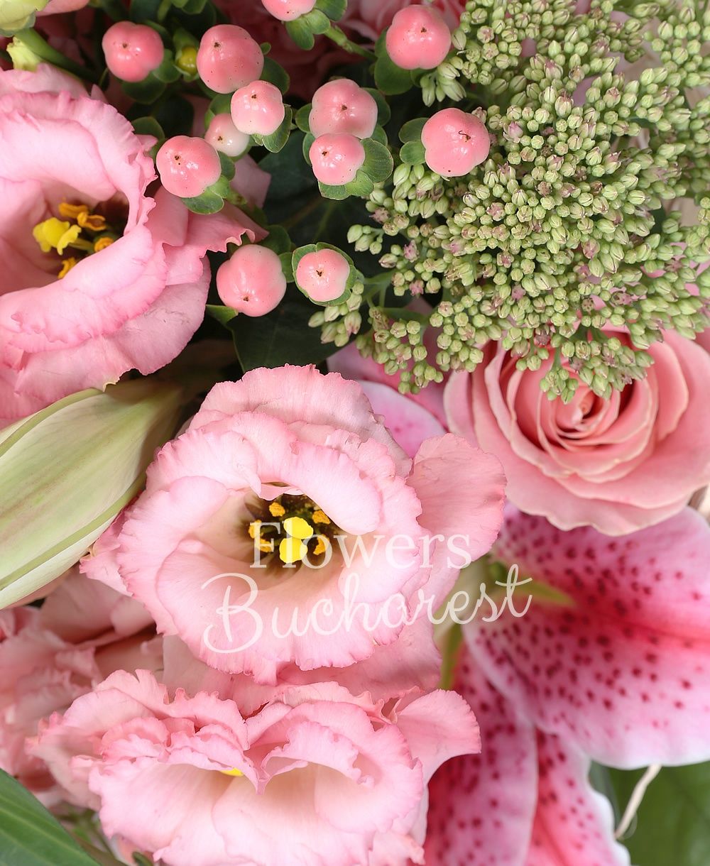 1 pink lily, 3 pink roses, 3 pink lisianthus, 5 pink hypericum, 3 pink bouvardia, 3 pink carnations, 2 sedum, greenery