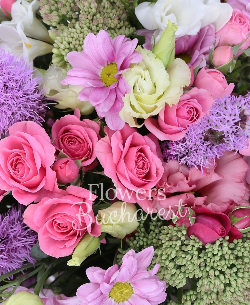 10 pink miniroses, 5 mauve liatris, 7 pink carnations, 3 sedum, 2 chrysanthemums, 10 white freesias, 3 pink lisianthus, basket