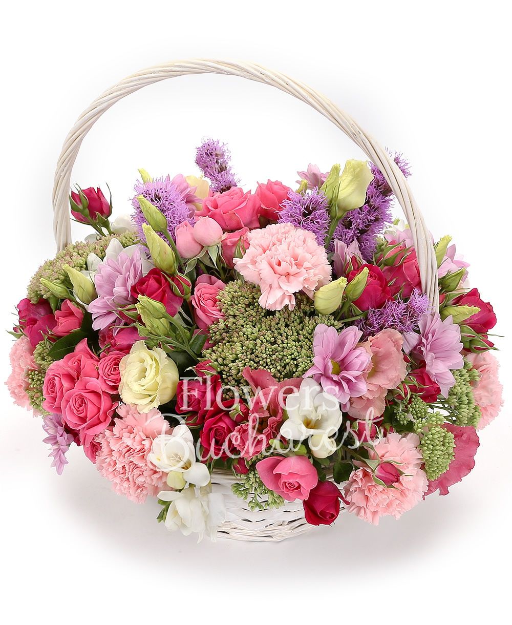 10 pink miniroses, 5 mauve liatris, 7 pink carnations, 3 sedum, 2 chrysanthemums, 10 white freesias, 3 pink lisianthus, basket