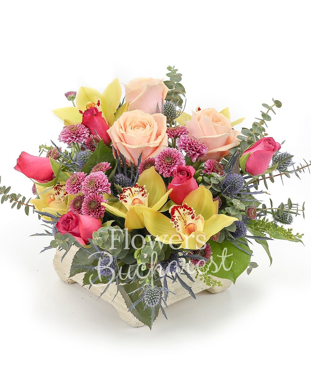 3 peach roses, 5 cyclam roses, 3 pink santini, 3 blue eryngium, yellow cymbidium, greenery