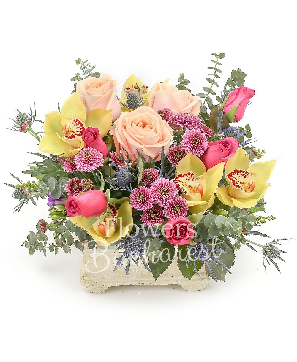 3 peach roses, 5 cyclam roses, 3 pink santini, 3 blue eryngium, yellow cymbidium, greenery