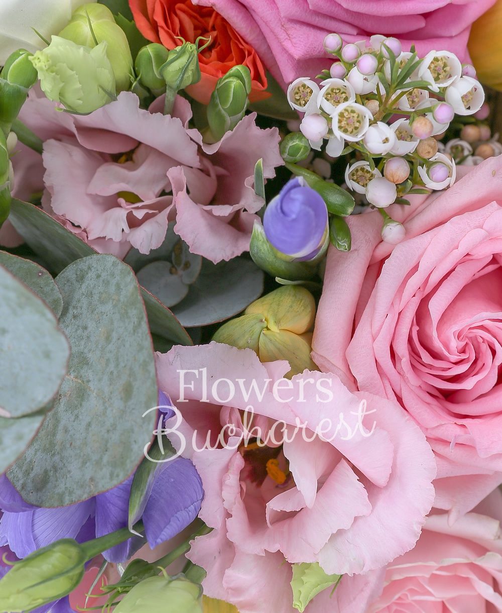 3 pink roses, 5 pink lisianthus, 2 white waxflower, 5 brunia, 5 iris, 3 orange miniroses, 5 yellow tulips, 5 white freesias, greenery