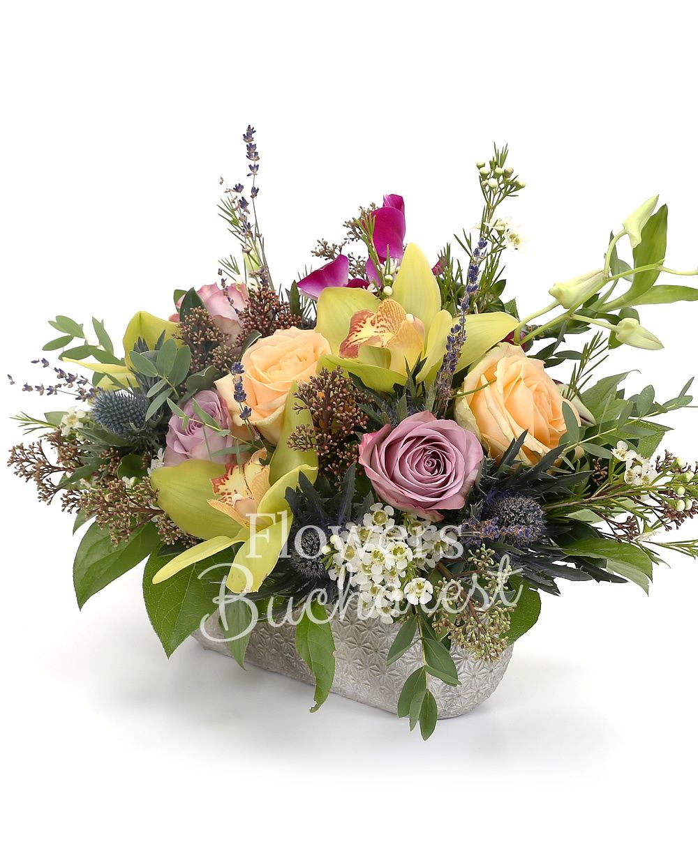 3 mauve roses, 3 cream roses, 2 dendrobium orchids, 1 eryngium, green cymbidium, greenery