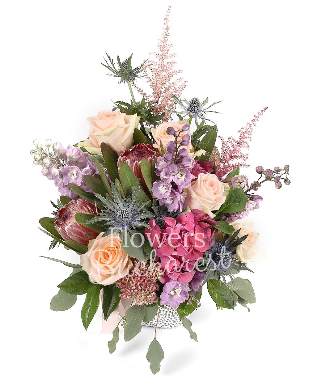 5 cream roses, 2 proteea, 3 purple delphinium, 2 astilbe, 2 eryngium, 2 hydrangeas, greenery