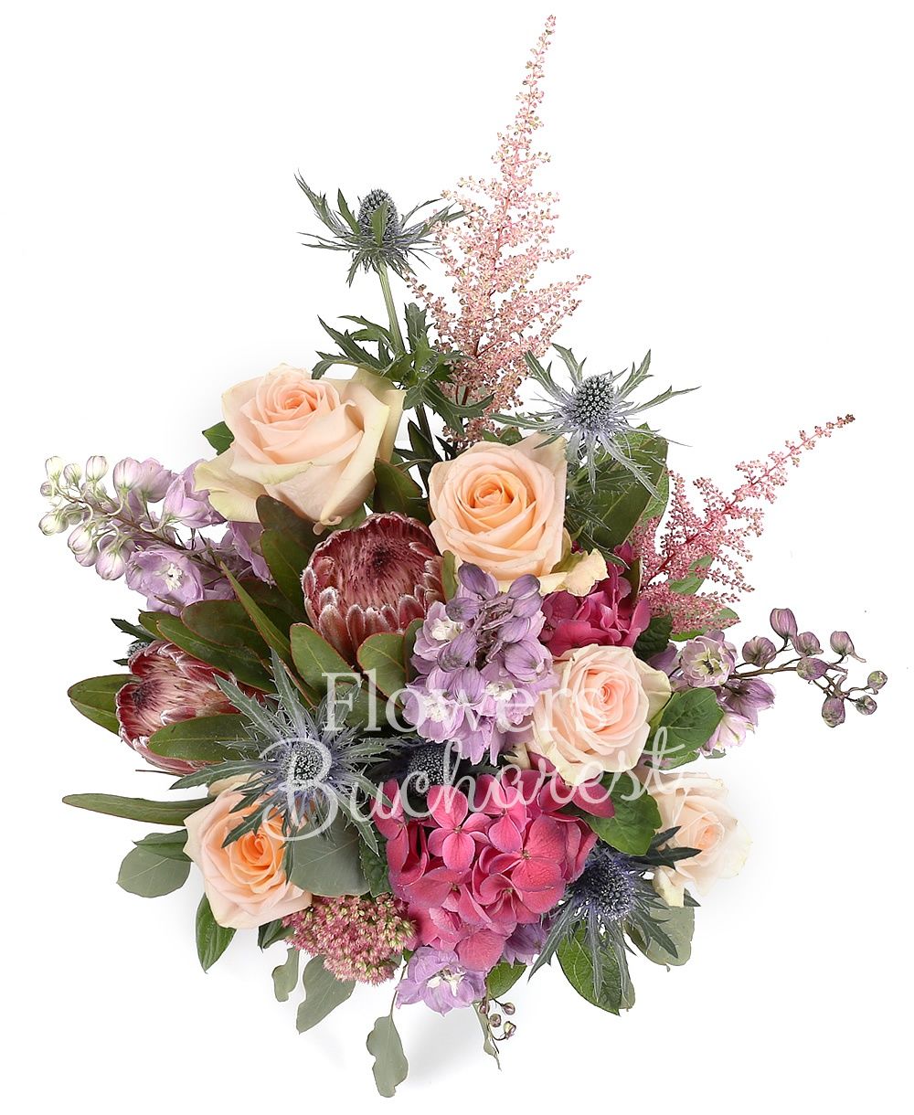 5 cream roses, 2 proteea, 3 purple delphinium, 2 astilbe, 2 eryngium, 2 hydrangeas, greenery