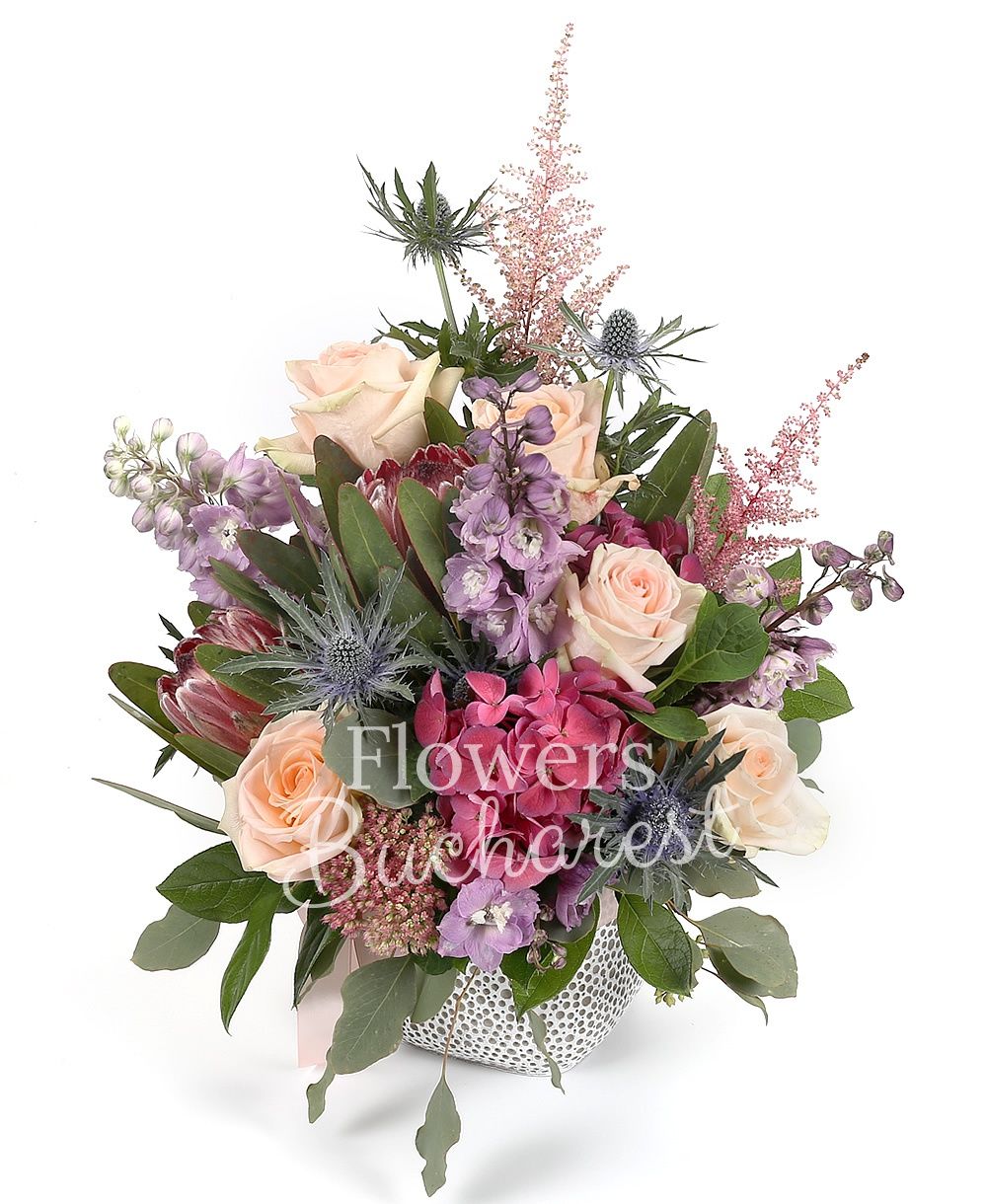 5 cream roses, 2 proteea, 3 purple delphinium, 2 astilbe, 2 eryngium, 2 hydrangeas, greenery