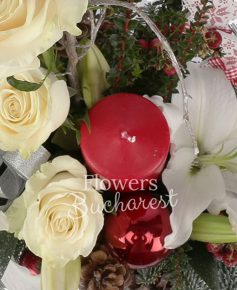 1 white lily, 3 white roses, 2 red hypericum, cones, globes, candle, greenery
