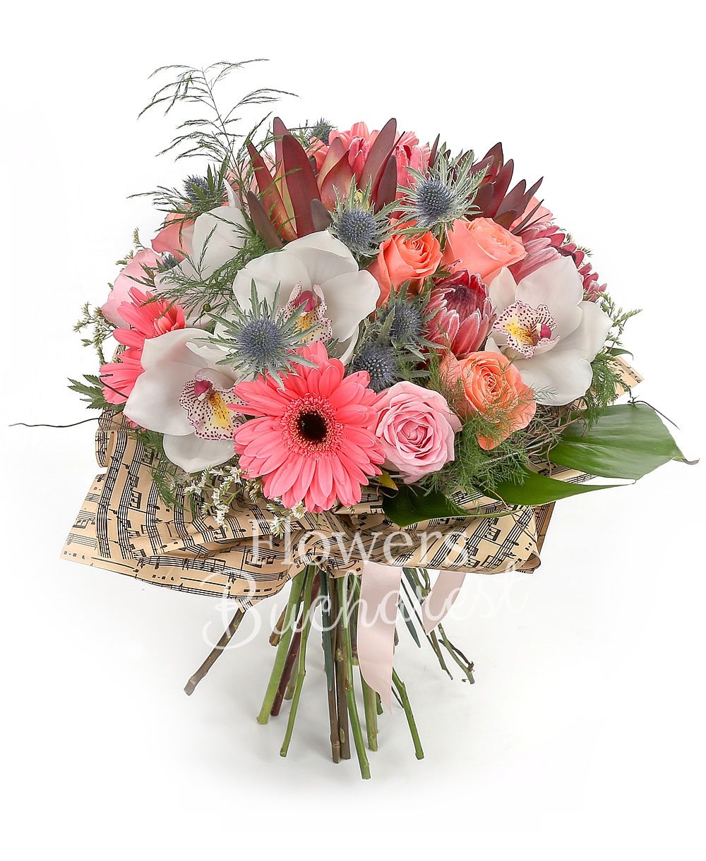 5 pink roses, 5 banana colour roses, 3 pink roses, 3 pink gerbera, 3 proteea, 3 leucadendron, 3 eryngium, white cymbidium, greenery