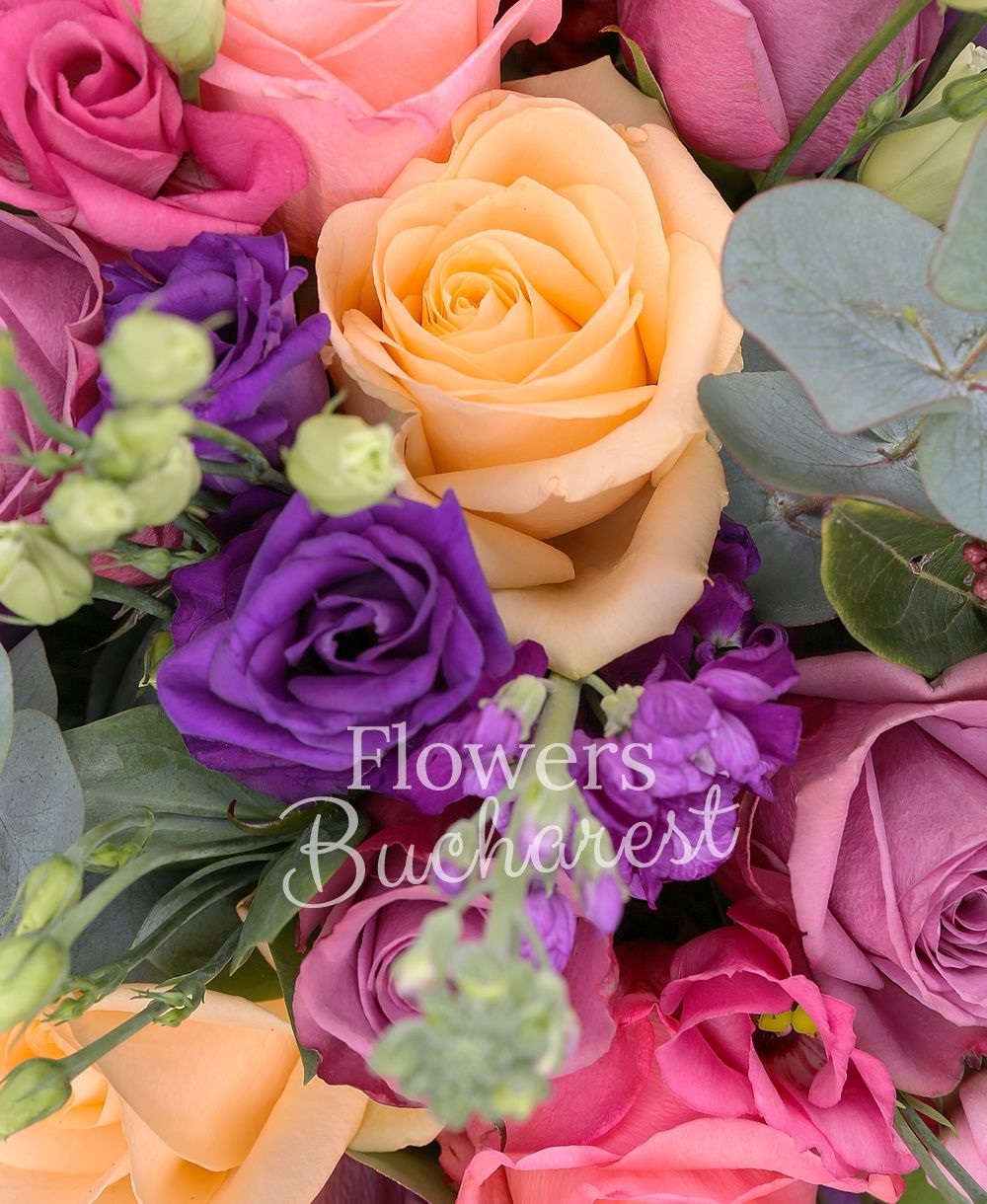 9 mauve roses, 5 banana colour roses, 5 pink roses, 5 mauve lisianthus, 5 mauve matthiola, 3 sedum, 3 anigozanthos, greenery