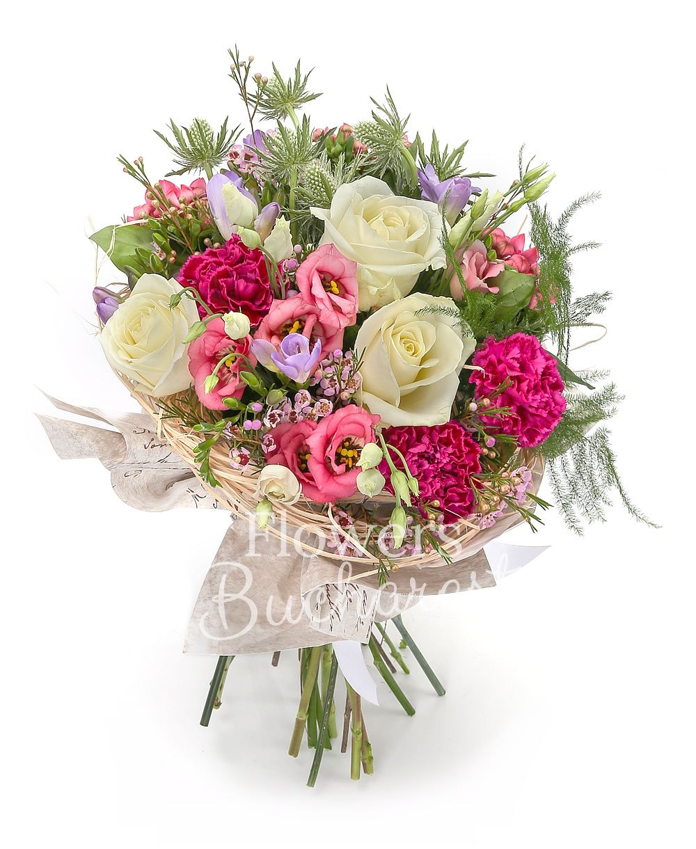 3 white roses, 5 pink lisianthus, 3 white eryngium, 5 purple freesias, 3 cyclam carnations, 3 pink bouvardia, waxflower, greenery